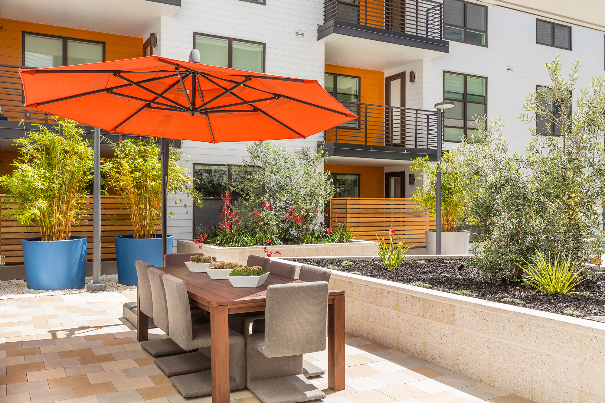 Rooftop area with family seating and patio umbrella.