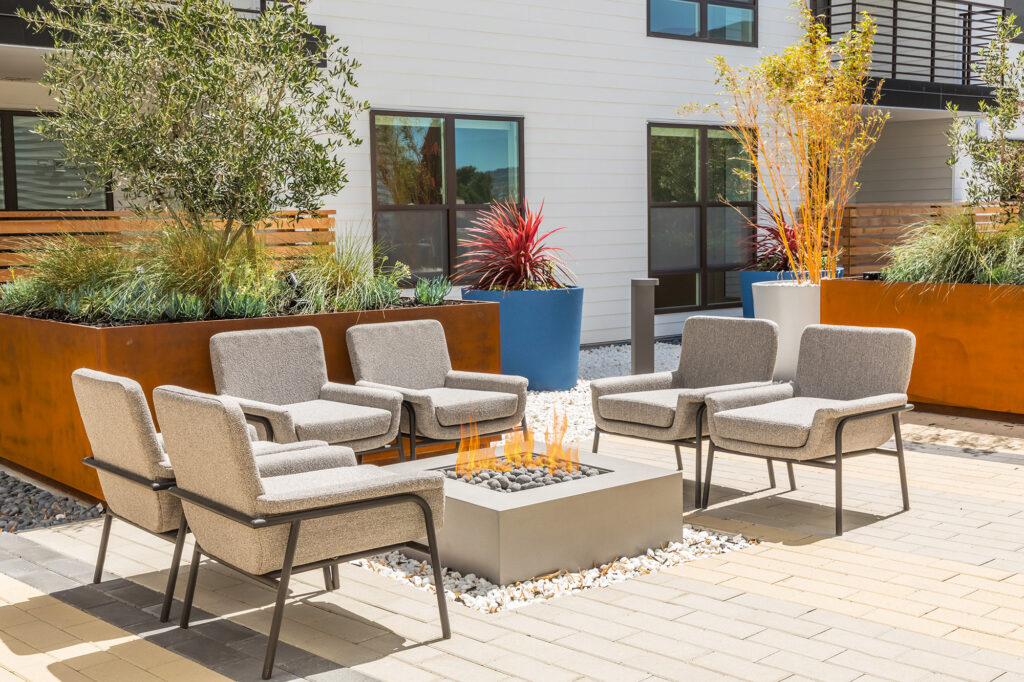 Fire pit with chairs and landscaping.