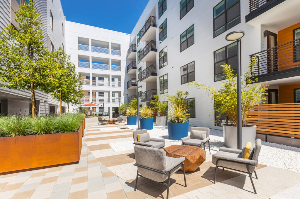 Patio area with seating and lush landscaping.